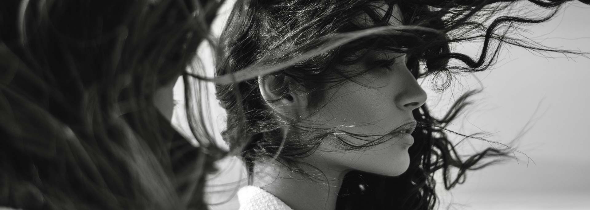 Black and white close up of windswept hair